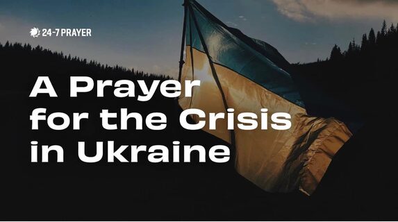 First slide of a prayer for Ukraine, with the background image of a Ukrainian flag blowing in the wind