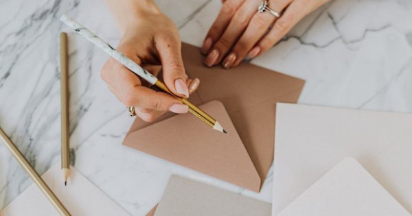 Featured image for Join Email List, showing a woman addressing envelopes