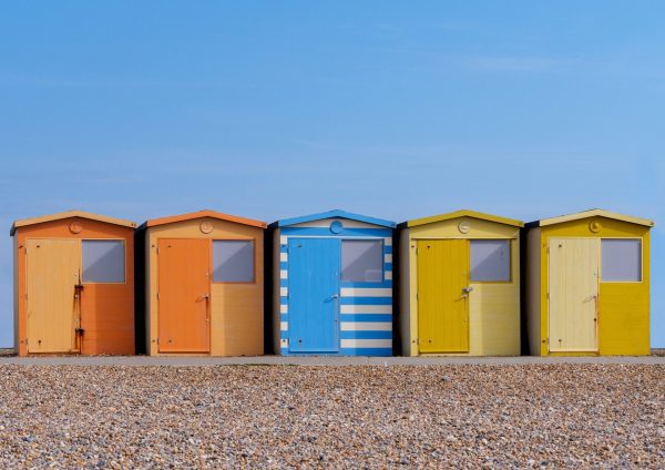 Beach huts and happiness image - bright cheerful english seaside scene