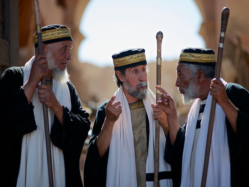 Three Jewish religious leaders in robes discussing Jesus
