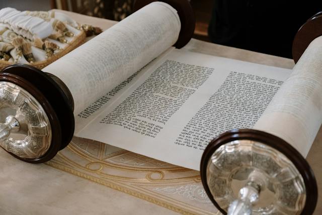 A Torah scroll opened out on a table